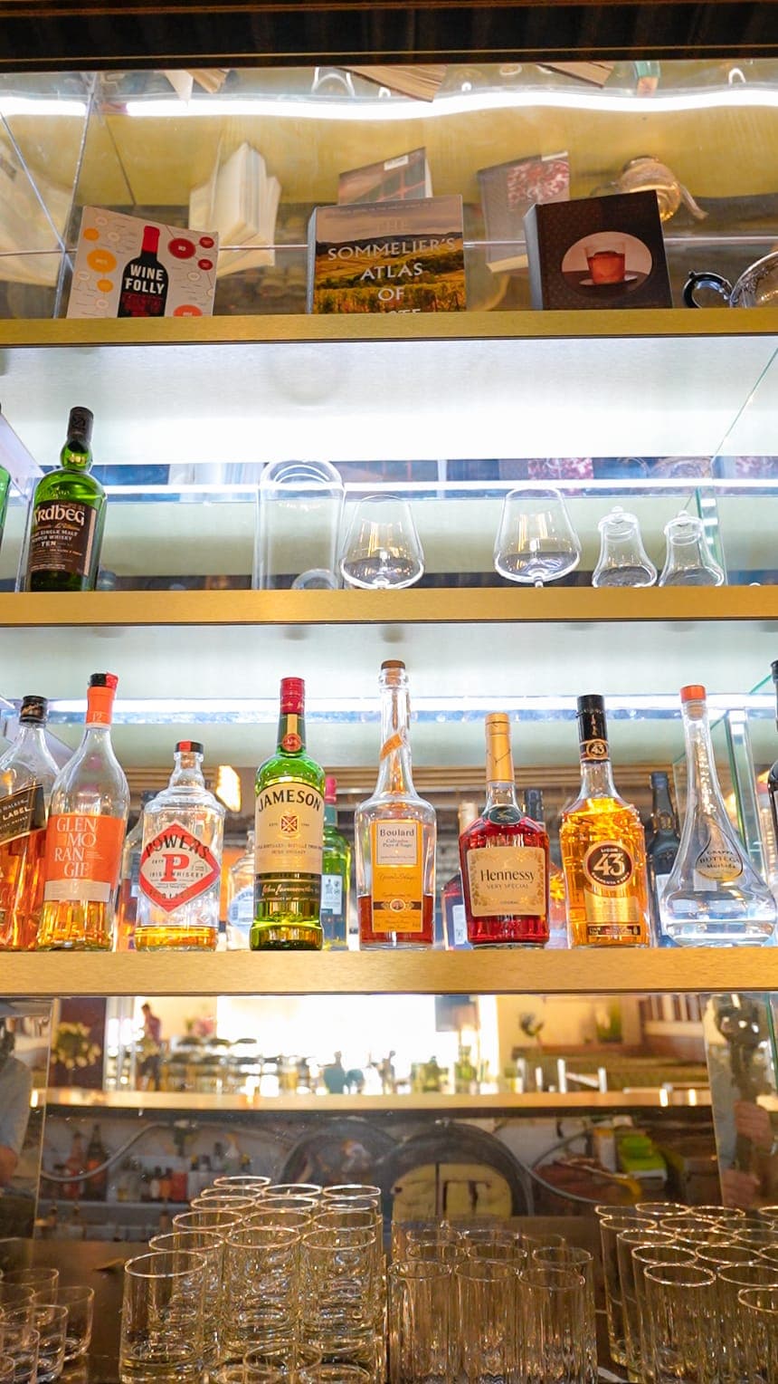 Backlit bottle display shelving behind the bar