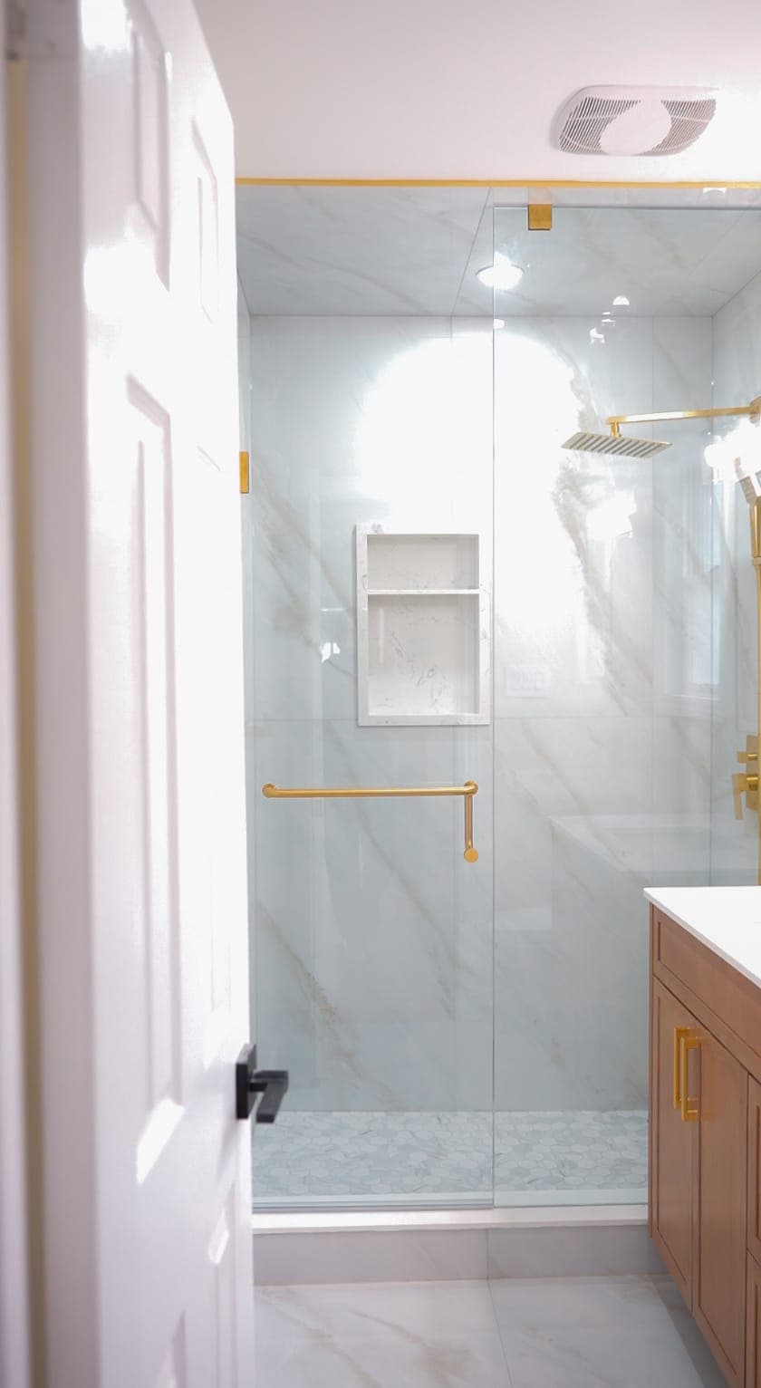 Built-in shower niche with marble tile