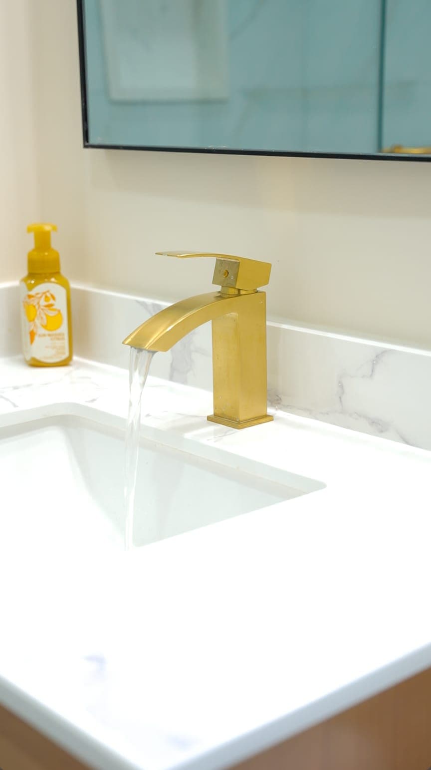 Bathroom vanity faucet detail with running water