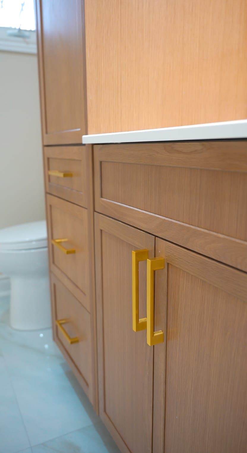 Bathroom cabinetry drawer and gold hardware detail