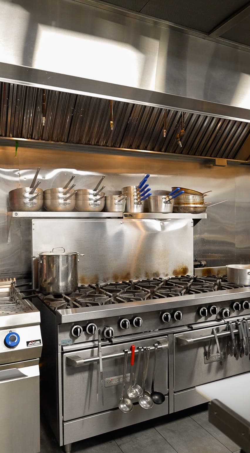 Commercial kitchen line detail with cookware