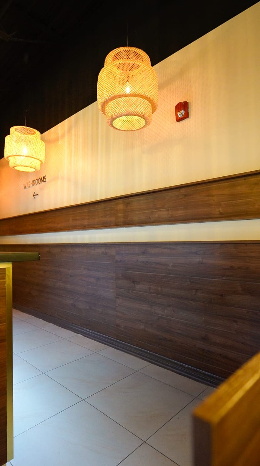 Corridor finish detail with wood paneling and pendant lighting